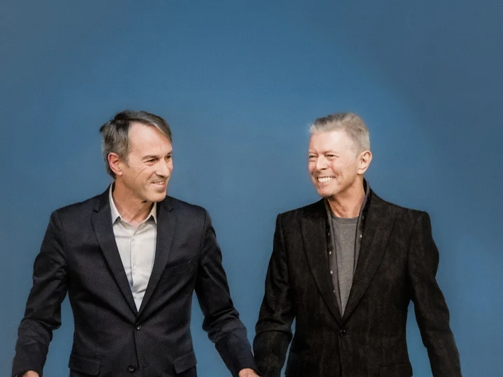 Ivo Van Hove with David Bowie against a blue background